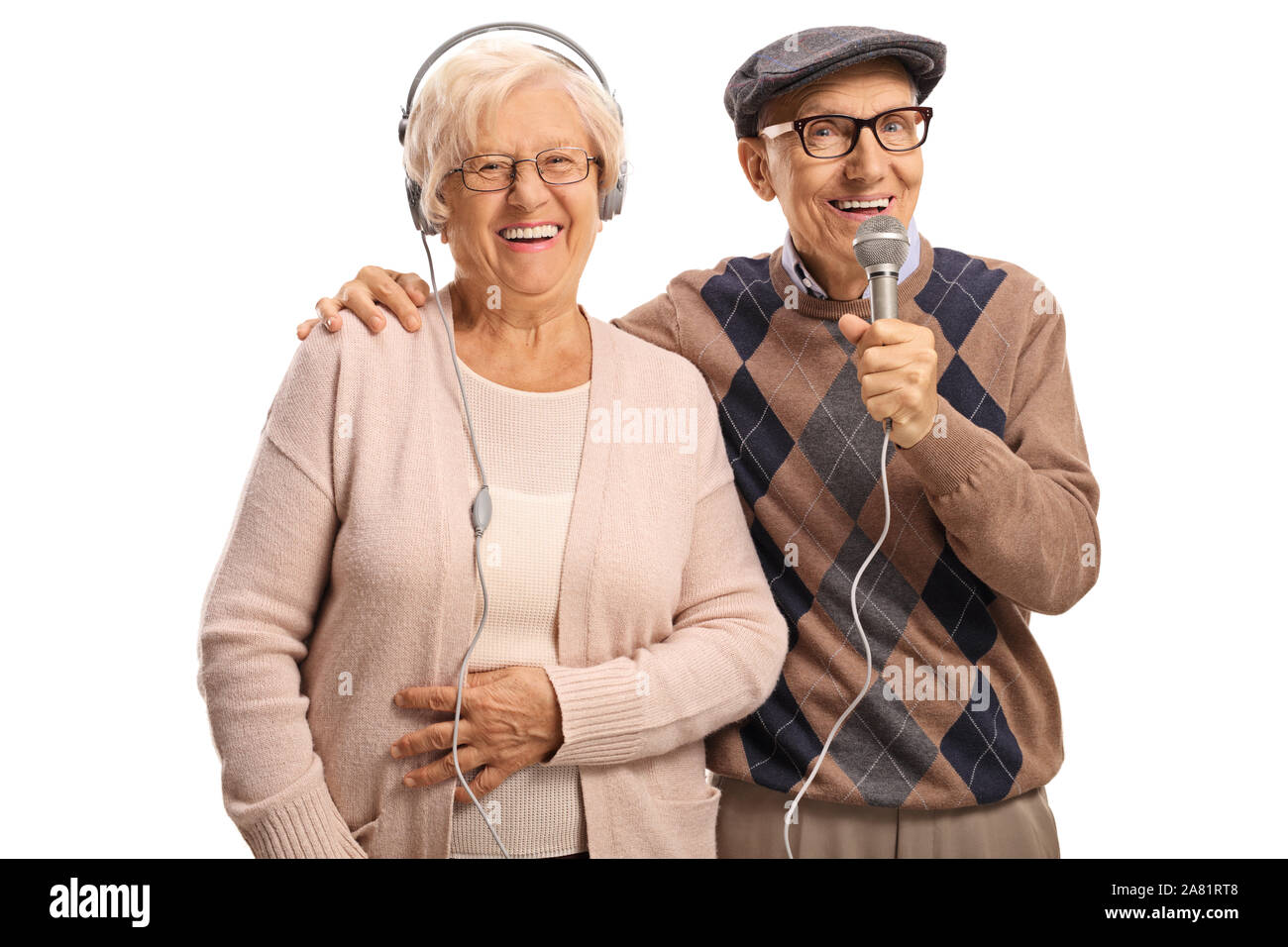 Elderly woman with headpones and an elderly man with a microphone isolated on white background Stock Photo