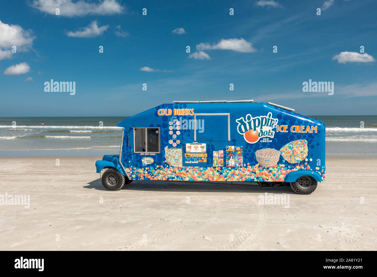 Blue Ice Cream Truck Driving On Daytona Beach Florida Selling Ice Cream