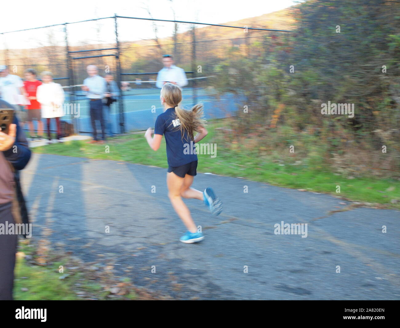 Middle school girl finishing first in New Jersey cross-country meet. Stock Photo