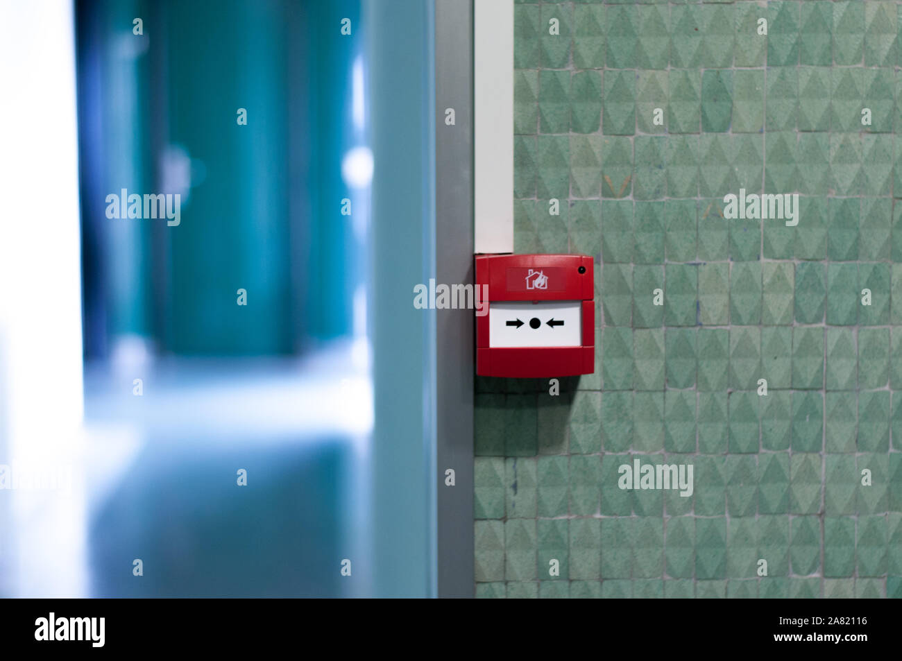 Fire alarm button on a green wall Stock Photo Alamy