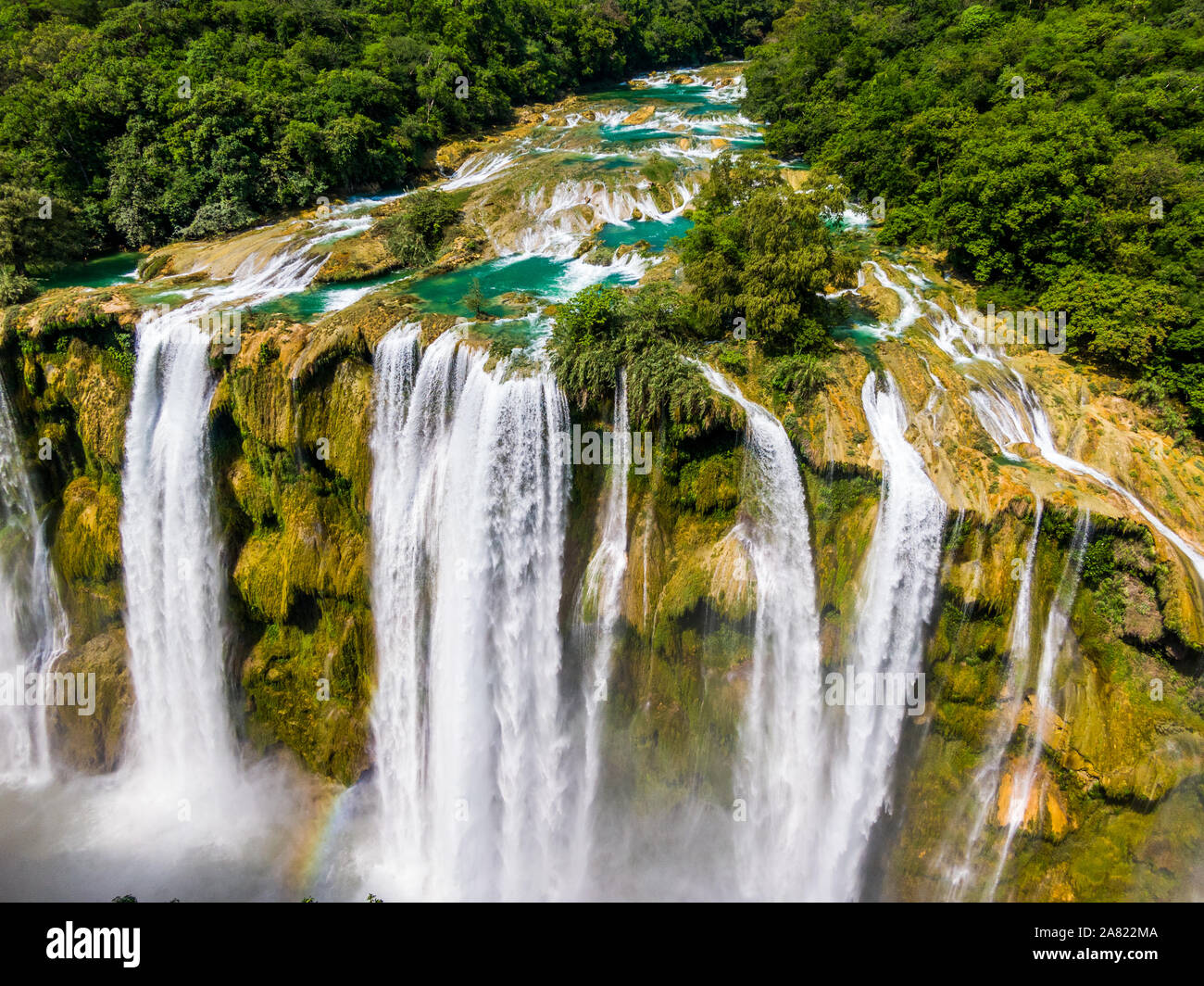 Aerial drone shot of the water fall Tamul in San Luis Potosi Mexico, water fall from a drone, green water fall, beautiful waterfall,Tamul water fall. Stock Photo