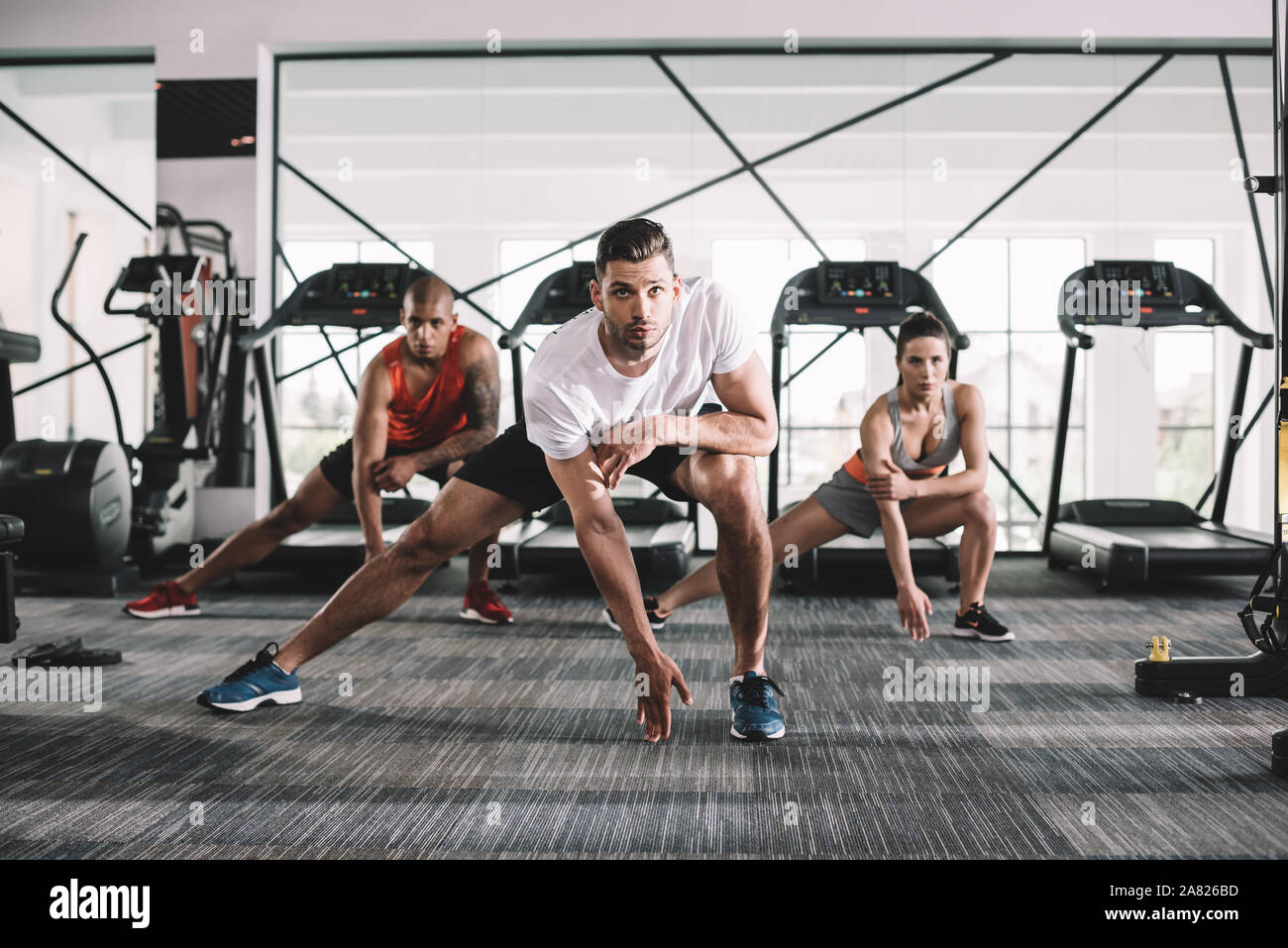 Multiethnic group athletes stretching together hi-res stock photography ...