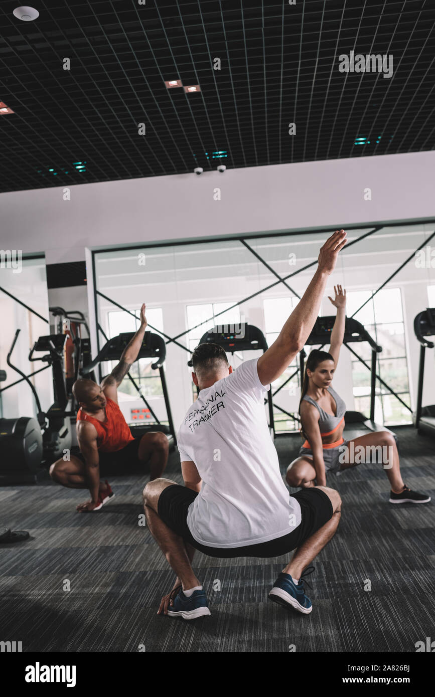 Multiethnic group athletes stretching together hi-res stock photography ...