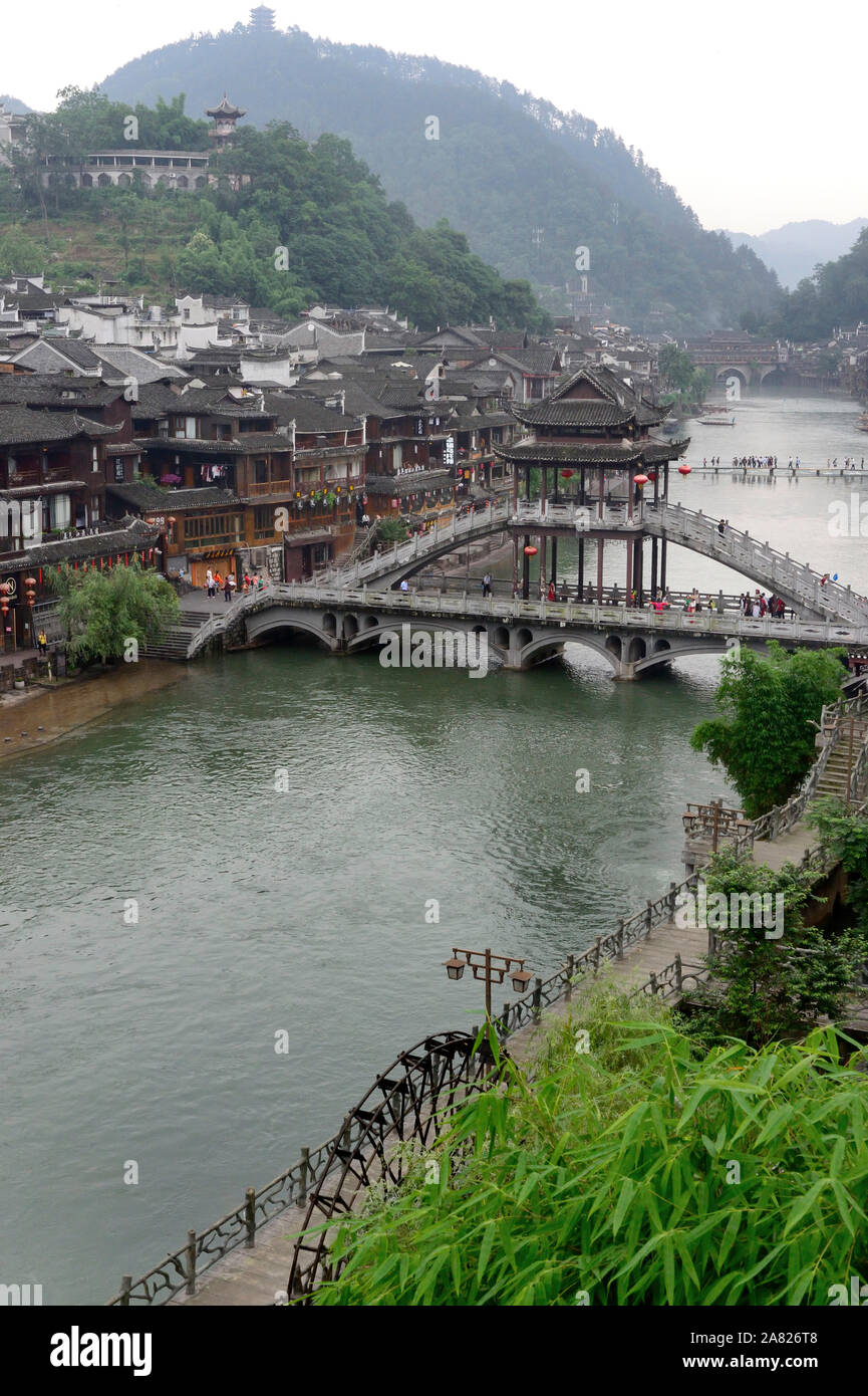 The picturesque water town, Fenghuang Ancient City, crosses the Tuo Jiang River with arched Nanhua Bridge, designed in traditional Chinese architectur Stock Photo