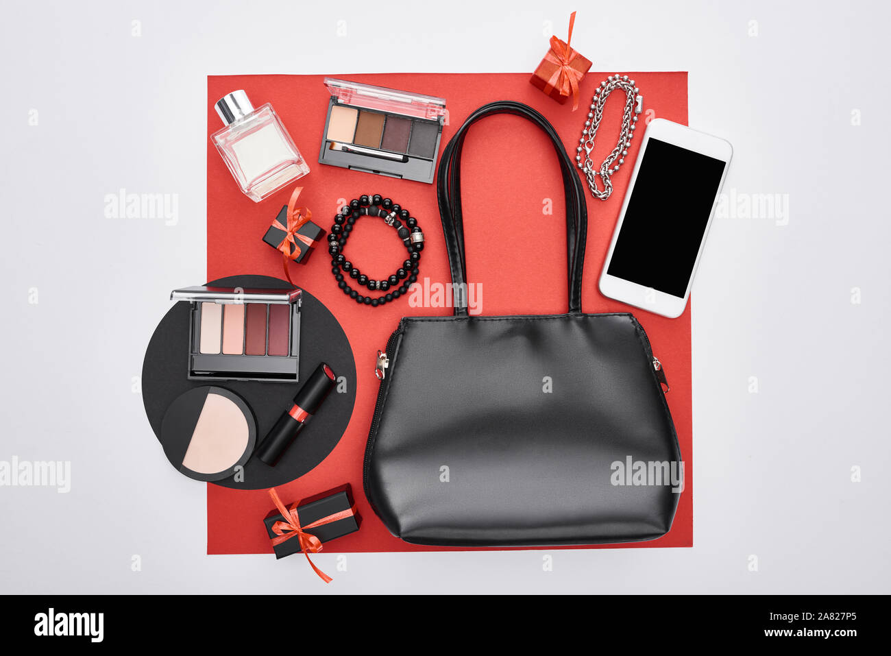 top view of gadget, gift boxes, perfume, bracelets, decorative cosmetics, bag Stock Photo