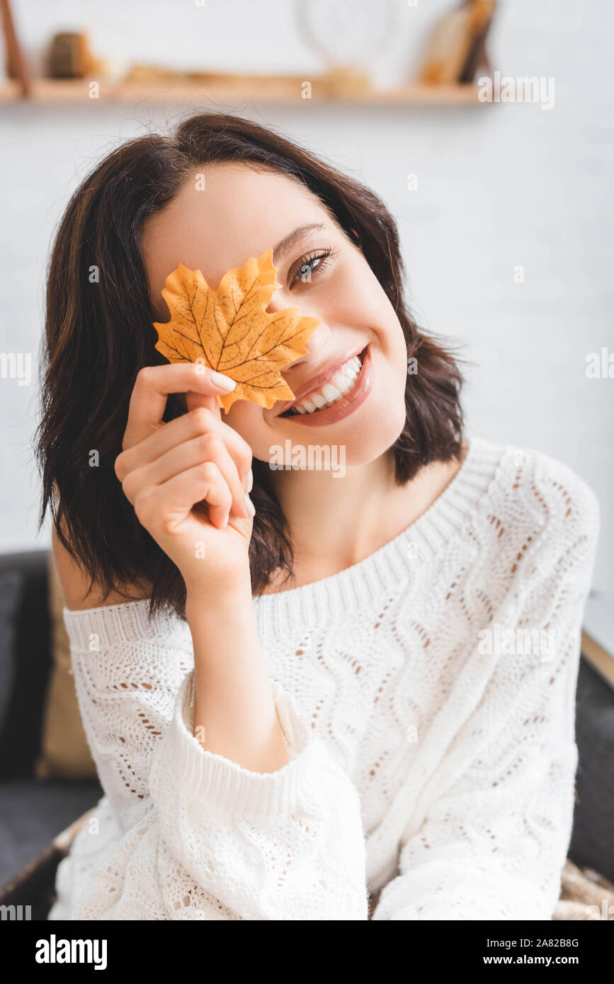 beautiful happy girl holding yellow autumn leaf in front of face Stock ...
