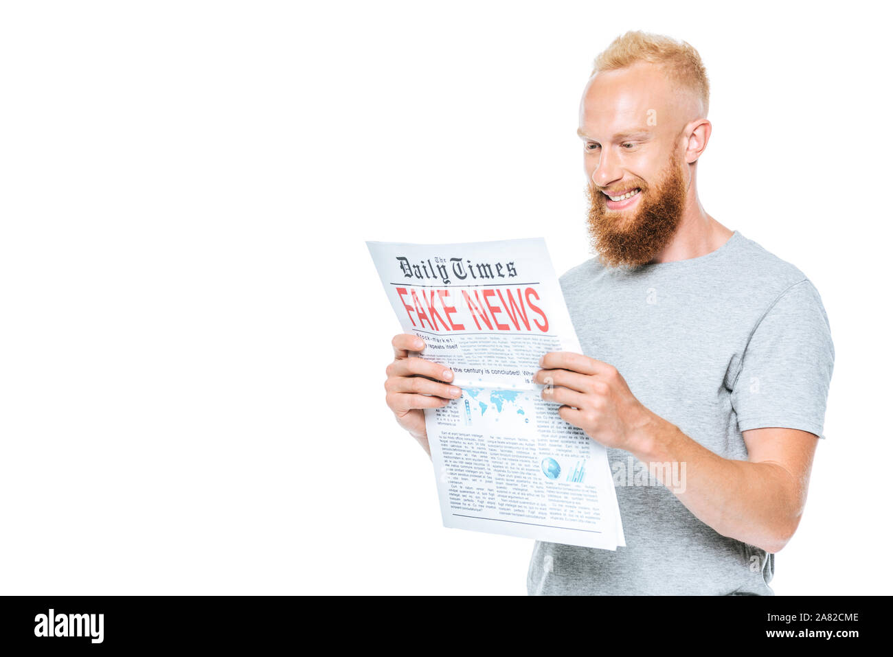 cheerful man reading newspaper with fake news, isolated on white Stock Photo