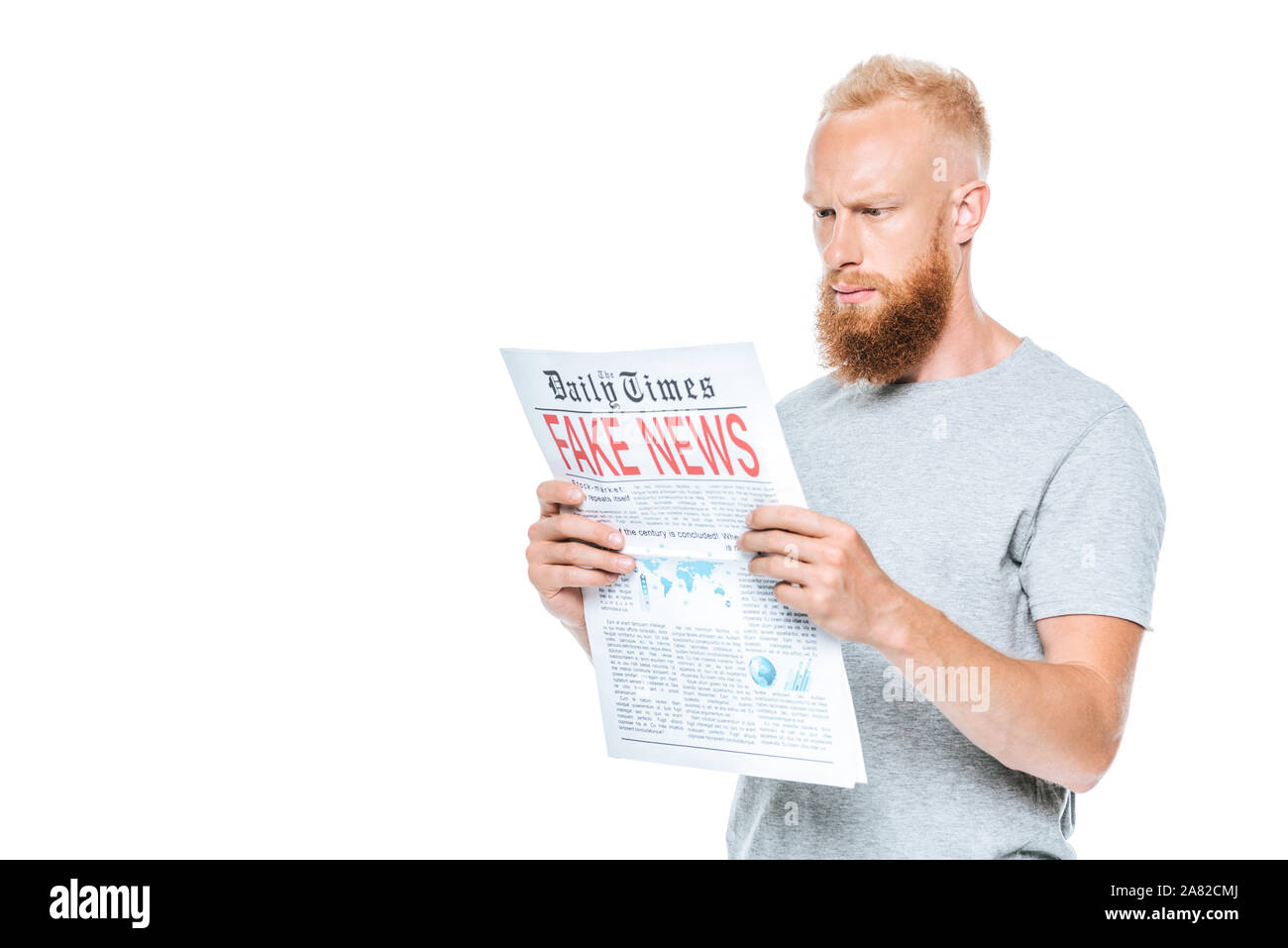 handsome serious man reading newspaper with fake news, isolated on white Stock Photo