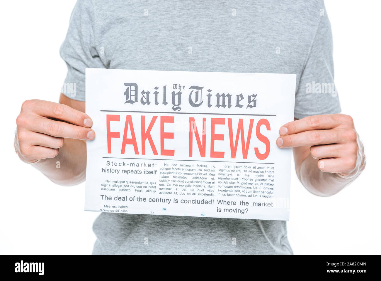partial view of man showing newspaper with fake news, isolated on white ...