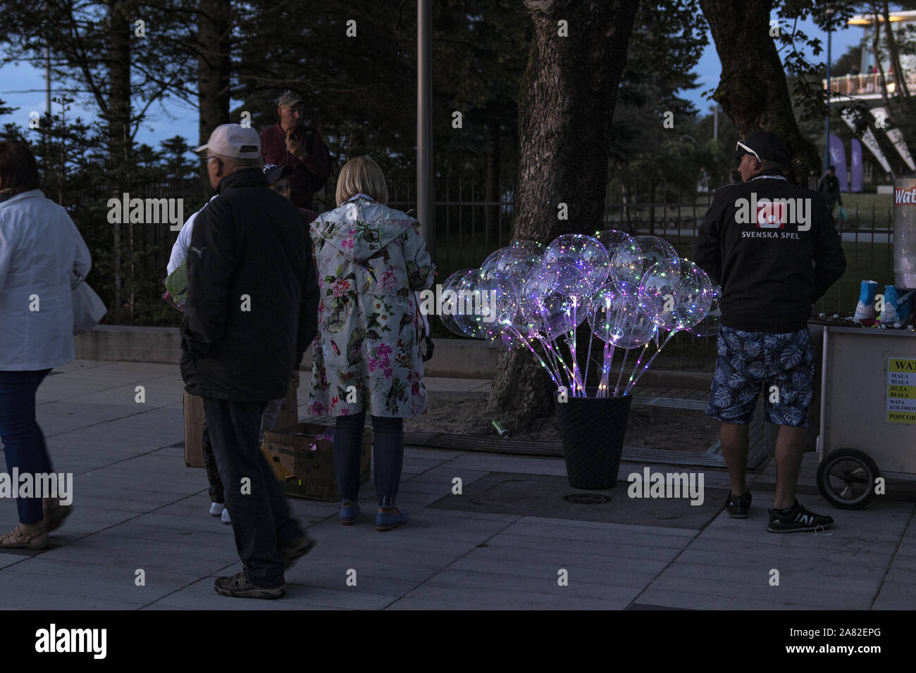 Street seller sells BoBo LED balloons on the promenade in the city of  Kolobrzeg in Poland while people take the evening stroll to the seashore  Stock Photo - Alamy