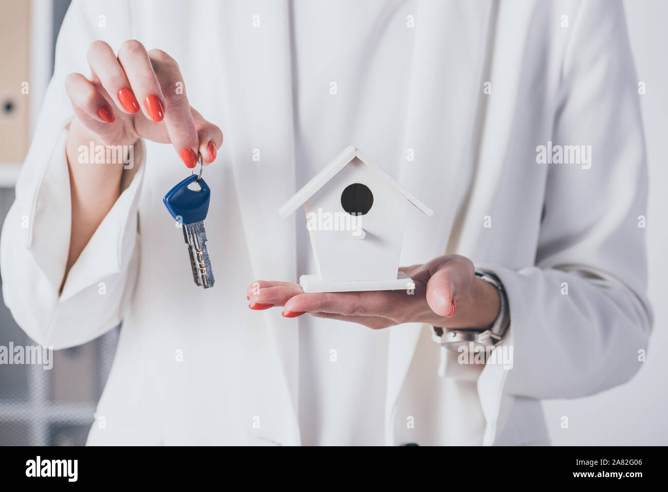 partial view of businesswoman showing house model and keys Stock Photo ...