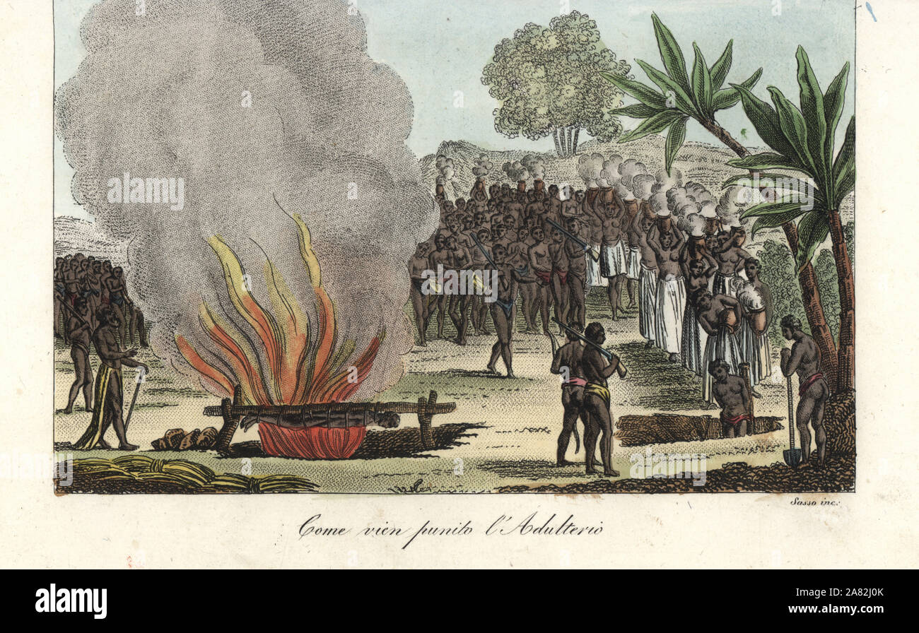 The punishment for adultery in Guinea (Slave Coast). A man is roasted alive in front of his lover, who is tied in a pit and scalded with boiling water. Handcoloured copperplate engraving by Antonio Sasso from Giulio Ferrario's Ancient and Modern Costumes of all the Peoples of the World, Florence, Italy, 1843. Stock Photo