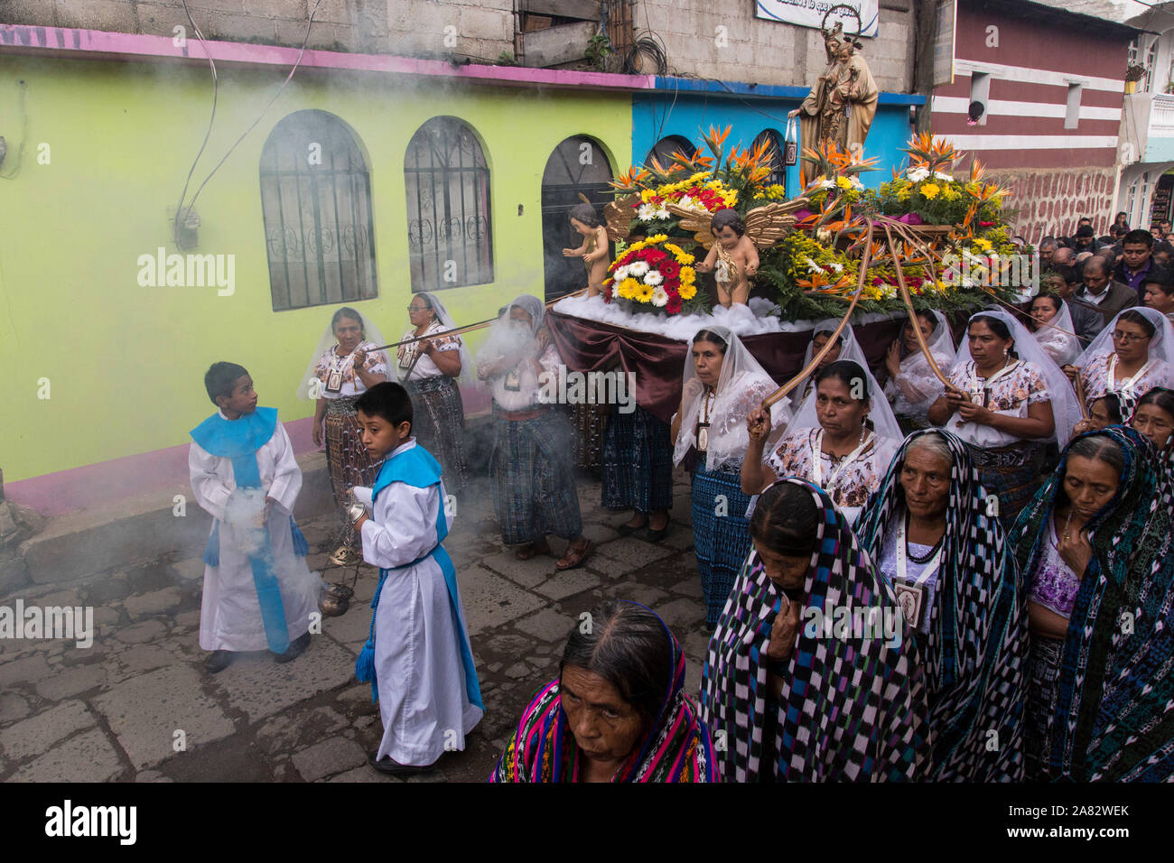 Young altar boys swing incense burners in the Catholic procession of