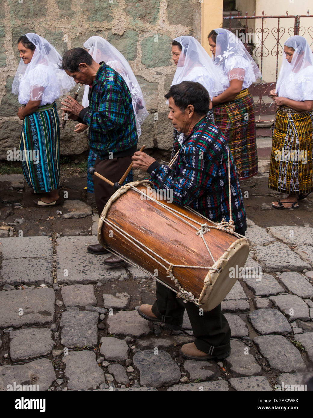 A traditional drummer and flute player in the Catholic procession of the Virgin of Carmen in San Pedro la Laguna, Guatemala.  Women in traditional May Stock Photo