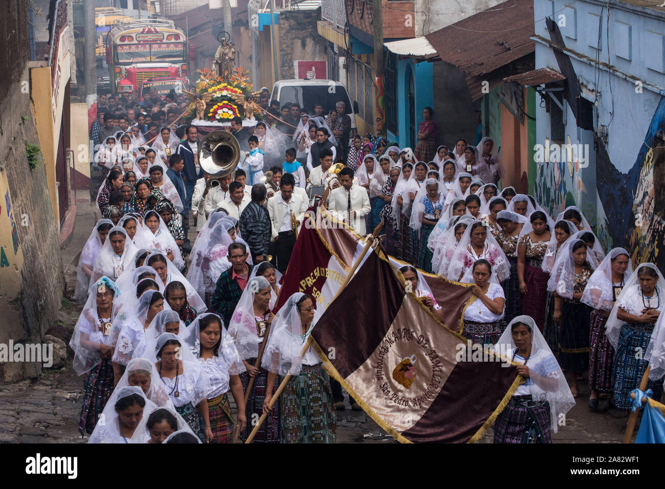 Catholic procession of the Virgin of Carmen in San Pedro la Laguna, Guatemala.  Women in traditional Mayan dress with white mantillas over their heads Stock Photo