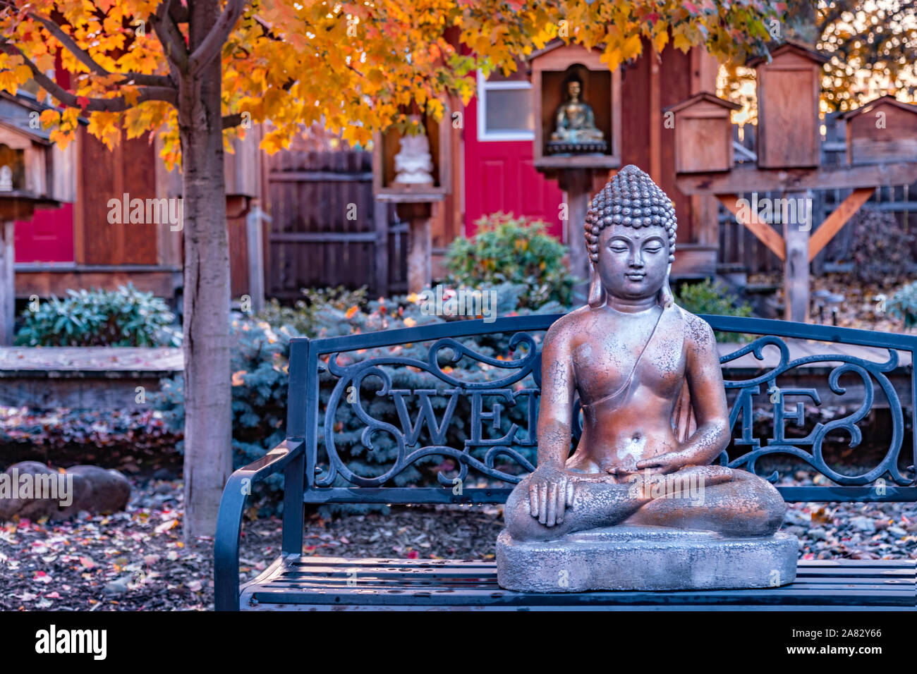Beautiful Buddhist garden with statue of Buddha with Bhumisparsa mudra Calling the Earth to Witness the Truth Stock Photo