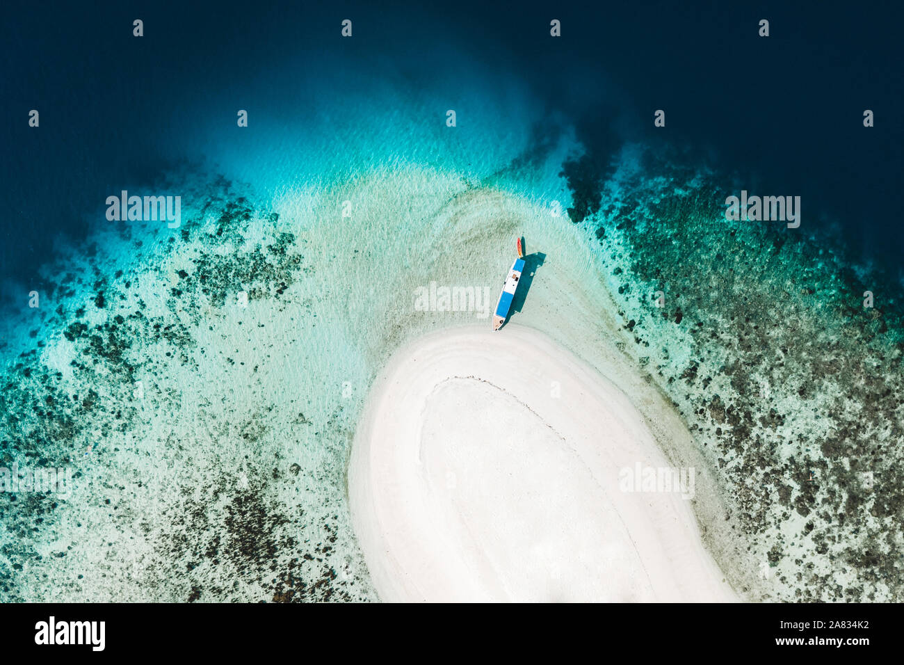 Aerial view of white sand beach on small tropical coral reef island ...