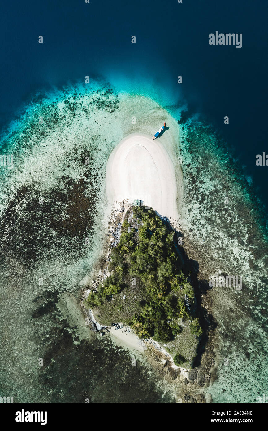 Aerial view of white sand beach on small tropical coral reef island ...