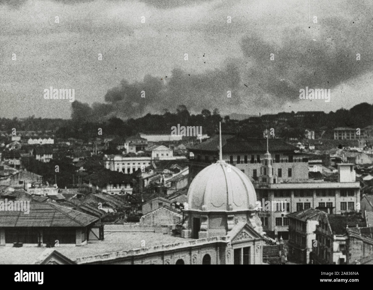 Last days at Singapore - Photograph shows bird's-eye view of Singapore during a Japanese air raid. 1942 Stock Photo