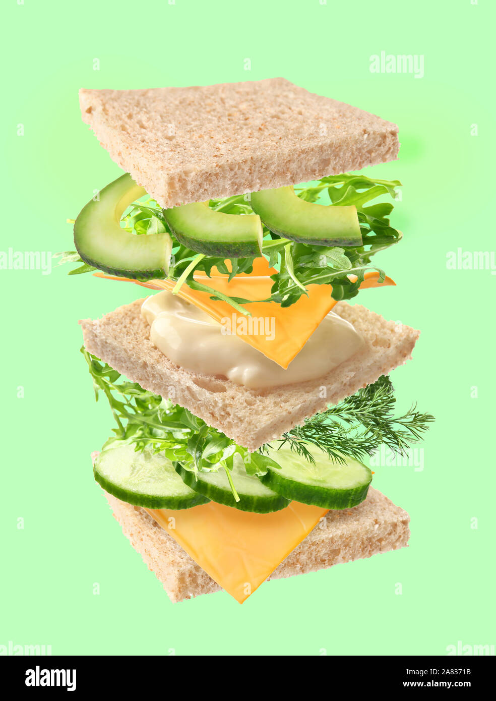Tasty sandwich with flying ingredients on color background Stock Photo