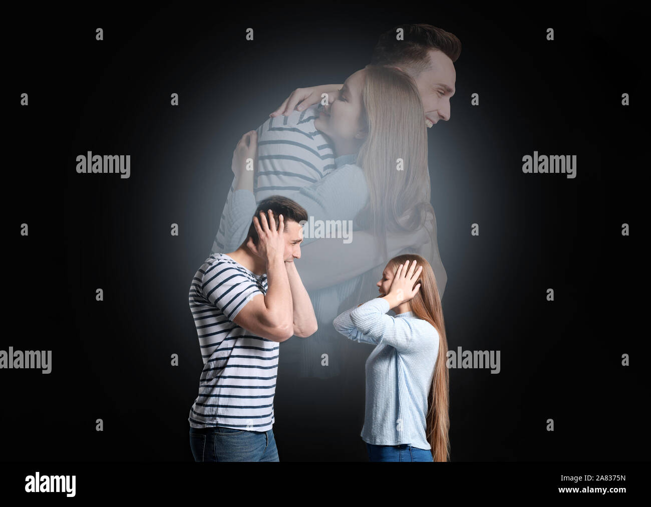 Quarreling young couple dreaming about making peace on dark background Stock Photo
