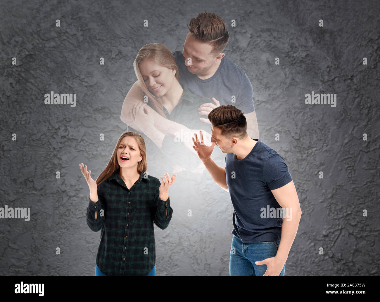 Quarreling young couple dreaming about making peace on grey background Stock Photo