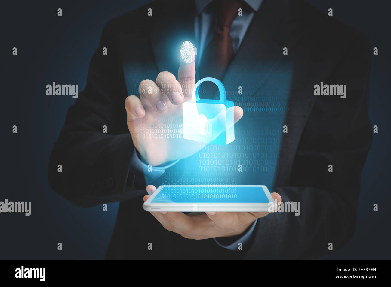 Businessman with tablet computer using fingerprint protection for data access Stock Photo
