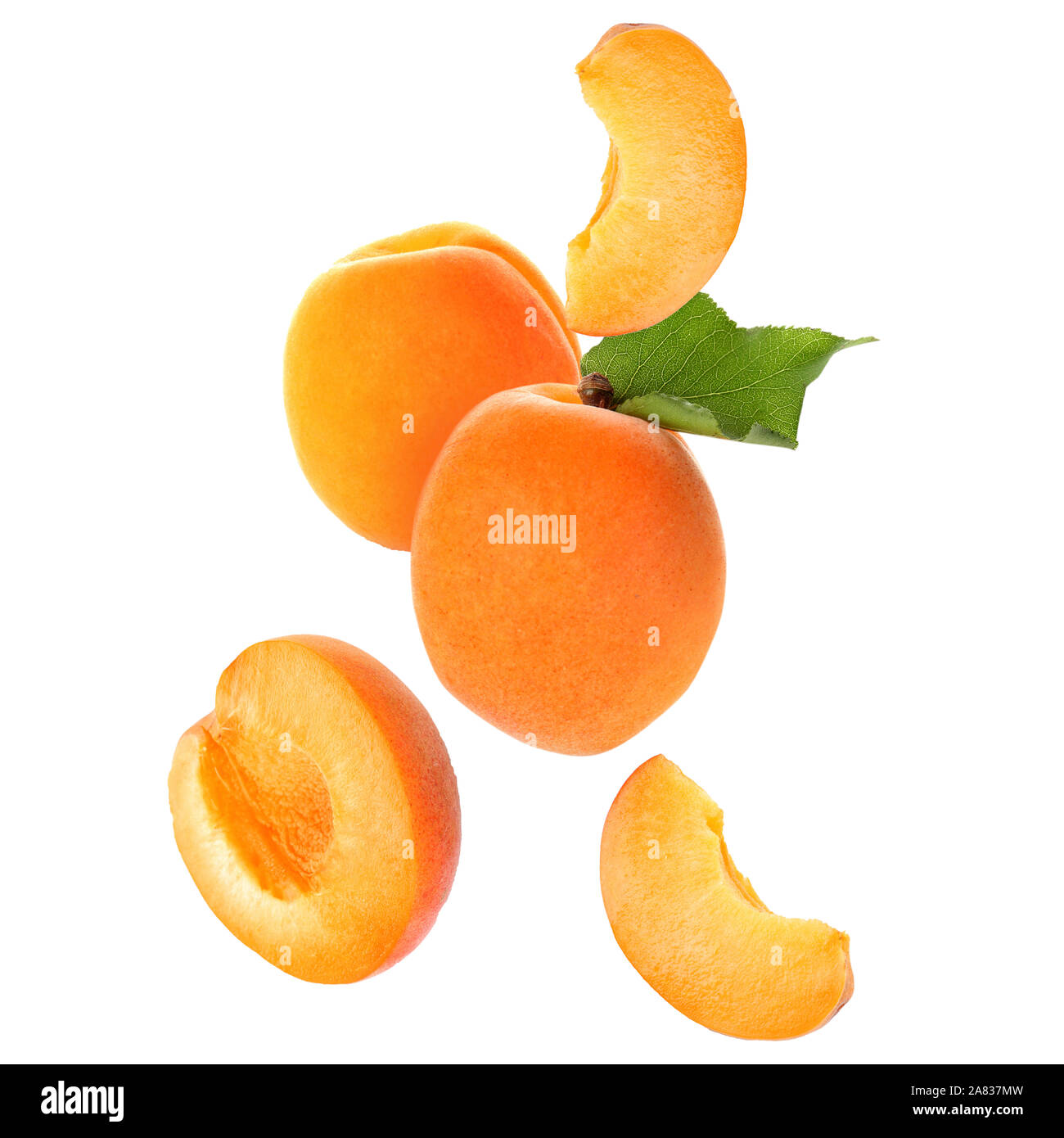Falling ripe apricots on white background Stock Photo