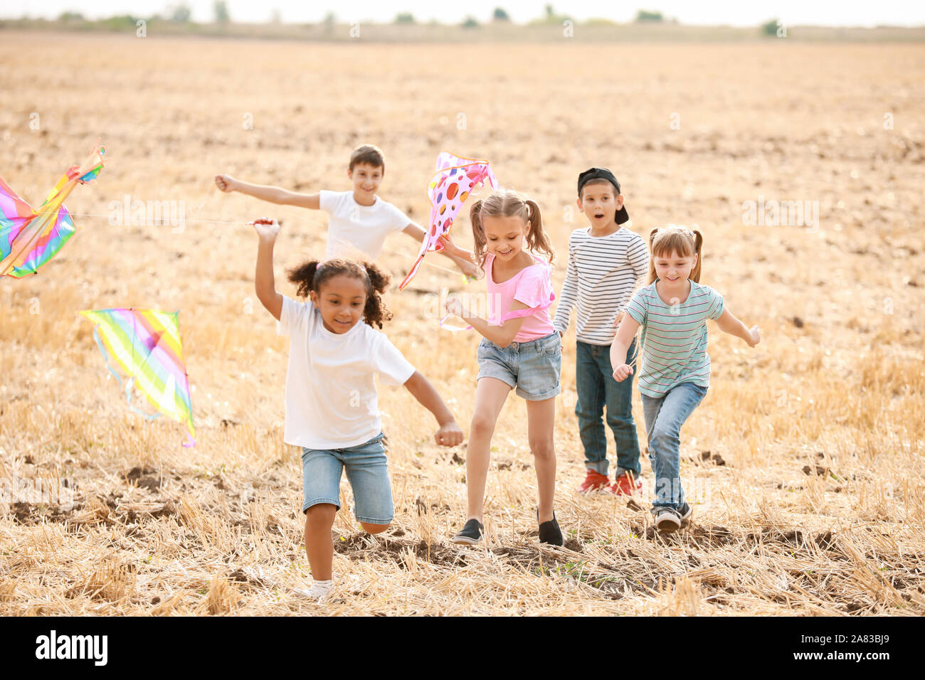 Little children flying kites outdoors Stock Photo - Alamy