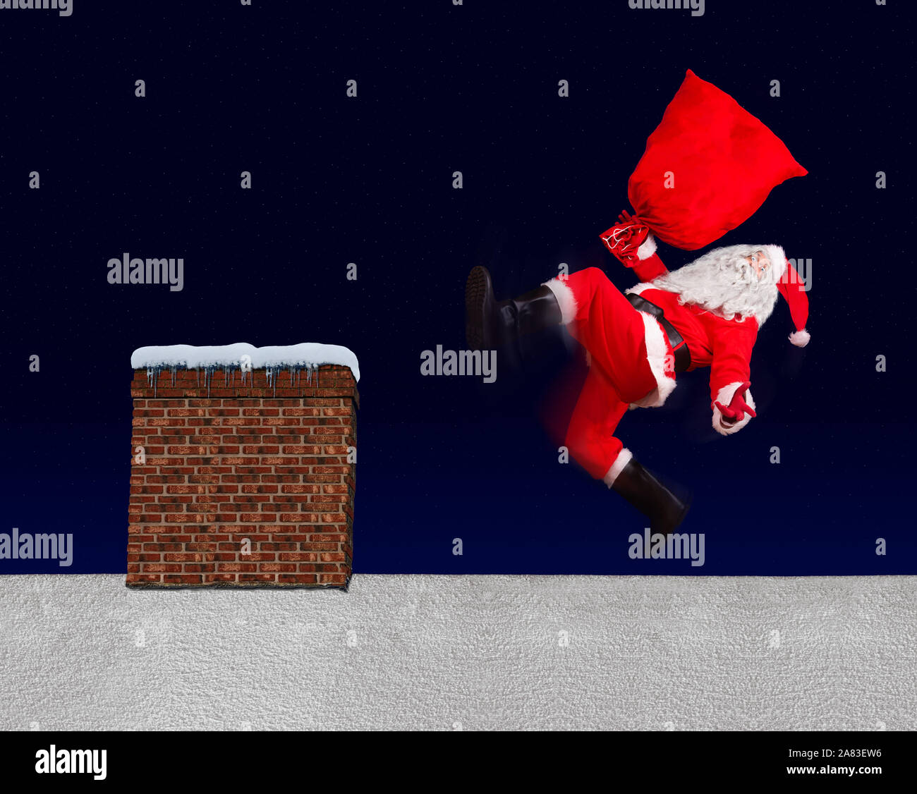 The unhappy Santa Claus slipped with bag on a snowy roof with the chimney. Santa Claus accident while distributing a gift. The Christmas disaster on a Stock Photo