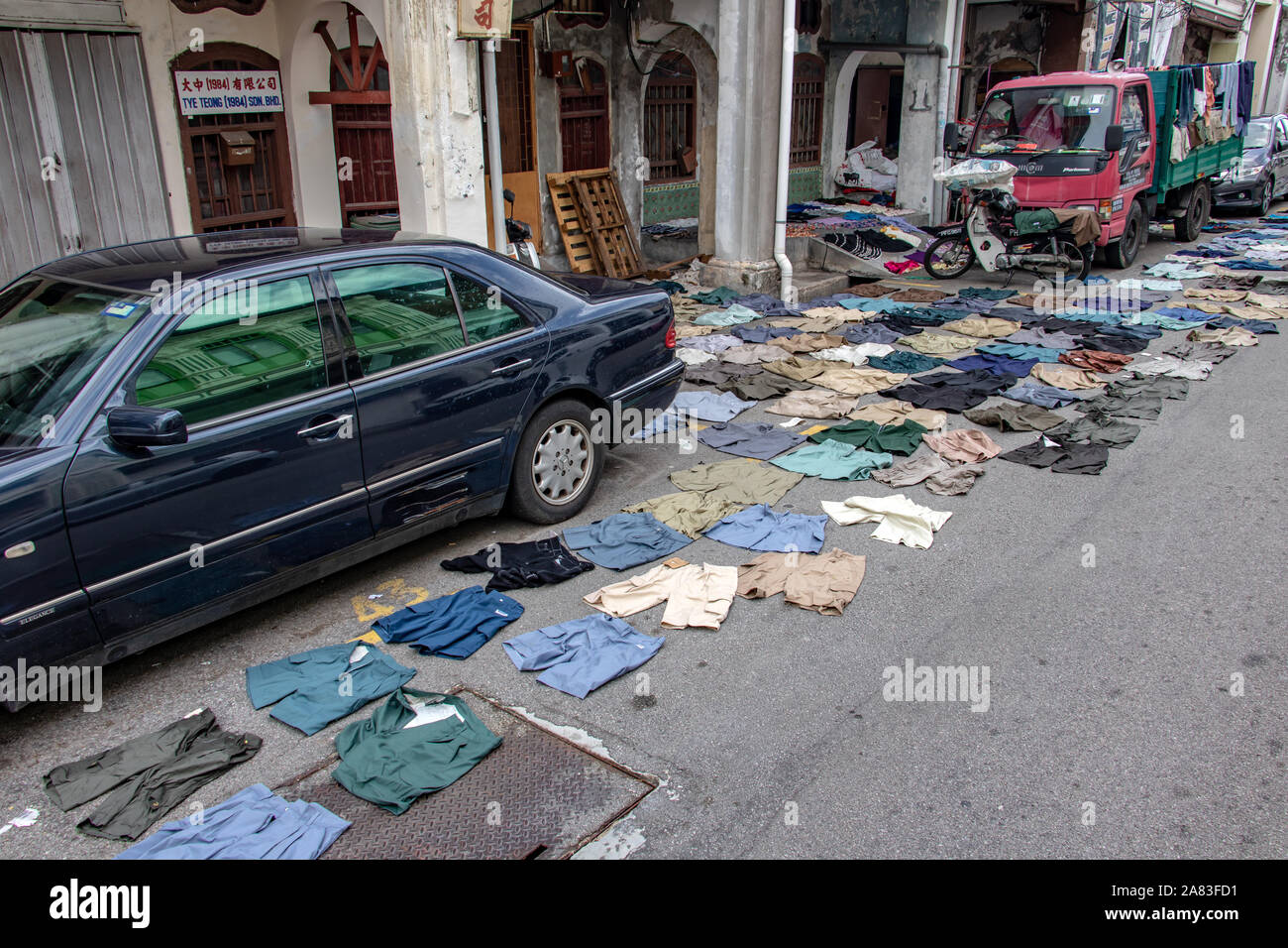 PENANG, MALAYSIA, NOV 12 2017, Short pants lying on the asphalt road. Drying clothes on the street of the city. Stock Photo