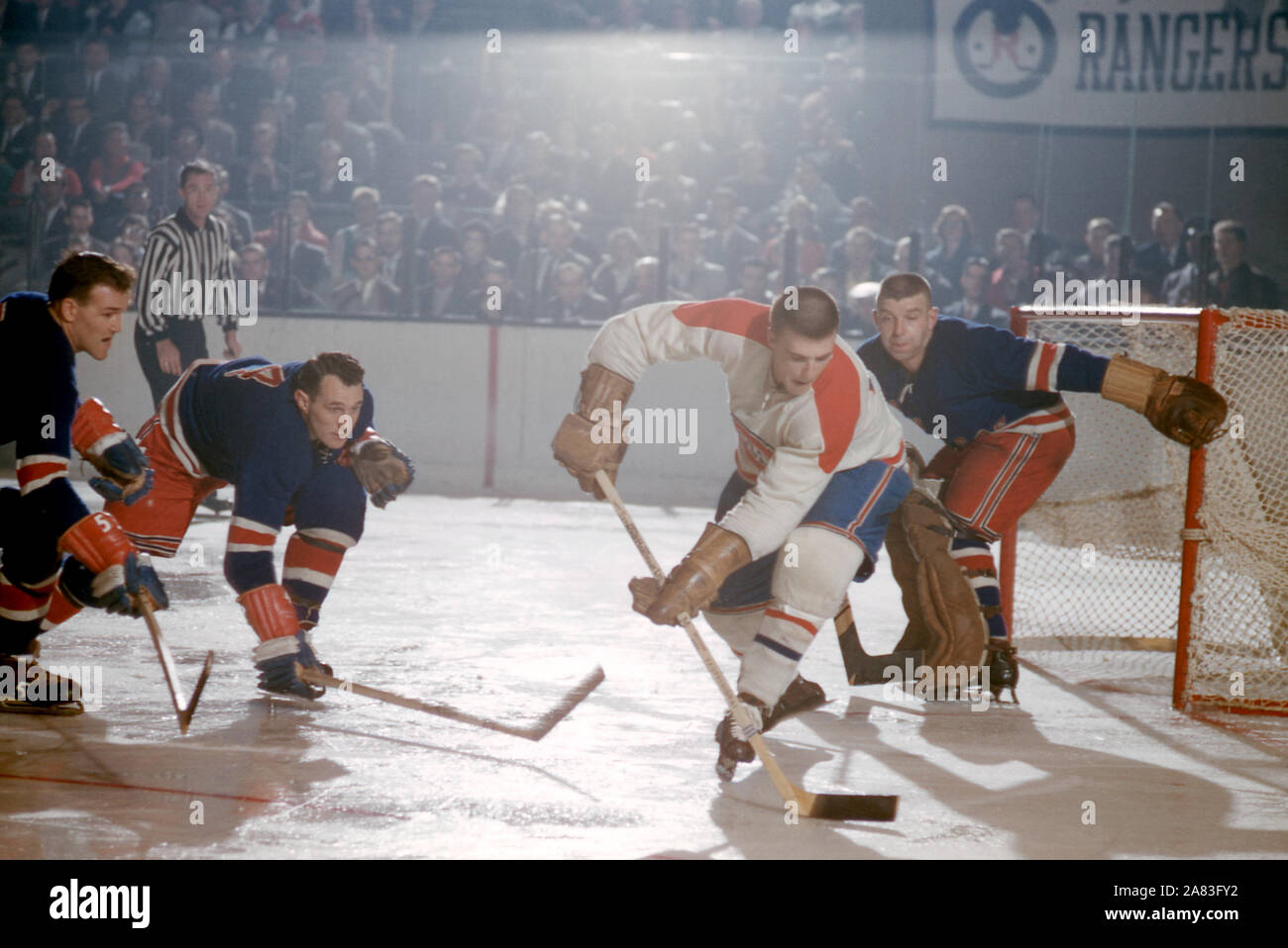 new-york-ny-october-27-jean-guy-talbot-17-of-the-montreal-canadiens-skates-with-the-puck-as-bill-gadsby-4-jack-evans-5-and-goalie-gump-worsley-1-of-the-new-york-rangers-defend-during-an-nhl-game-on-october-27-1957-at-madison-square-garden-in-new-york-new-york-photo-by-hy-peskin-local-caption-jean-guy-talbotbill-gadsbyjack-evansgump-worsley-2A83FY2.jpg