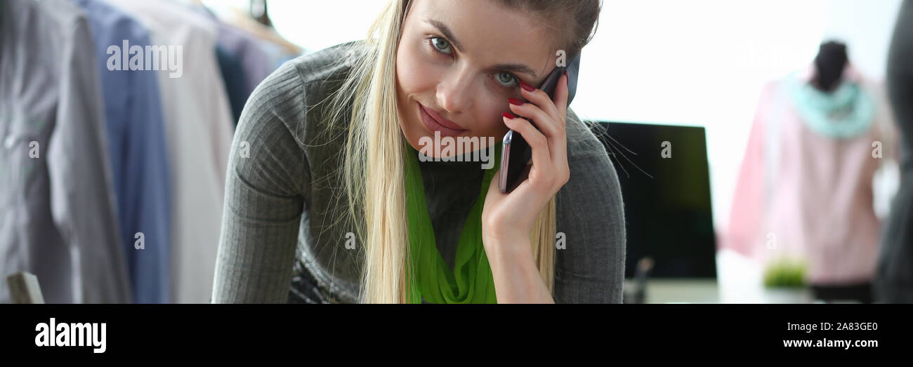 Clothes Design and Retail Designer Talking Phone Stock Photo