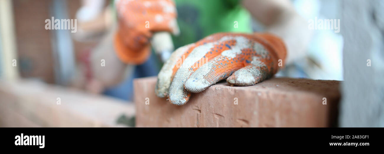 Male hands putting bricks Stock Photo - Alamy