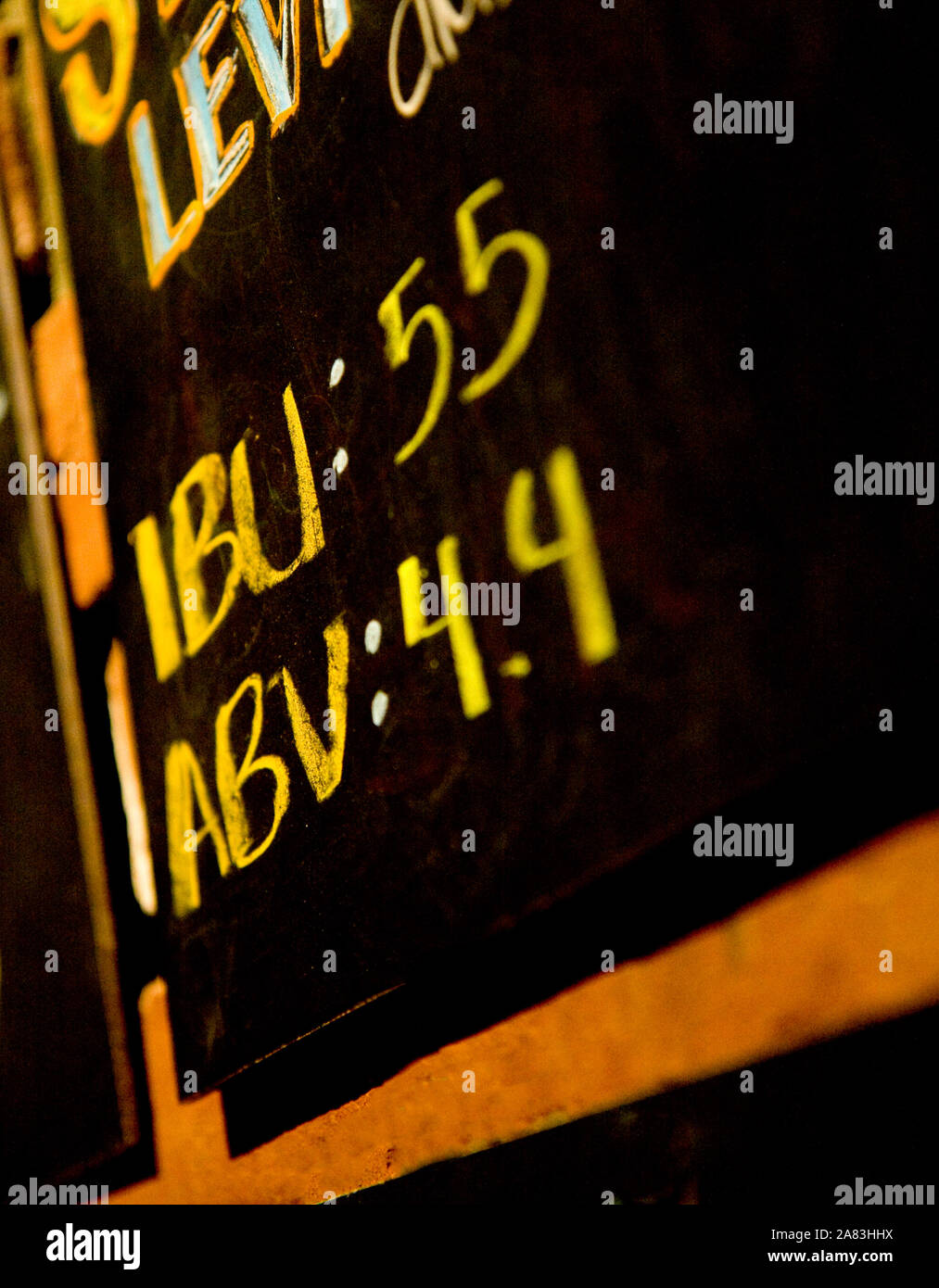 Close up of Chalkboard sign in restaurant with IBU and ABV information for beers. Stock Photo