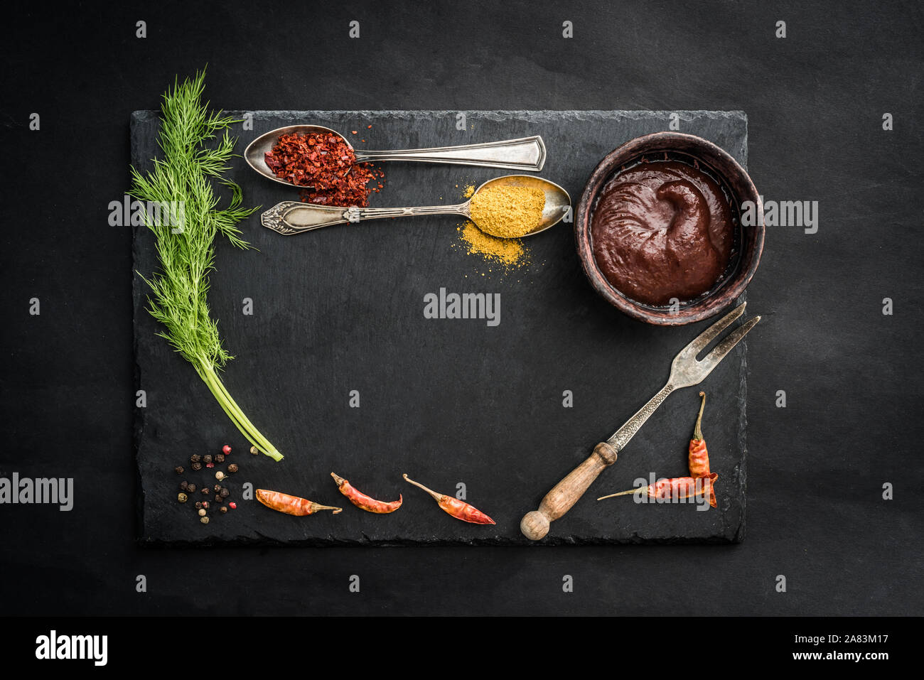 Black slate board with spices Stock Photo