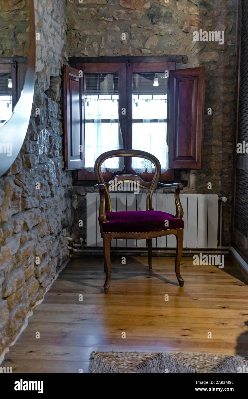 Old wooden chair close up isolated on a stone wall room Stock Photo