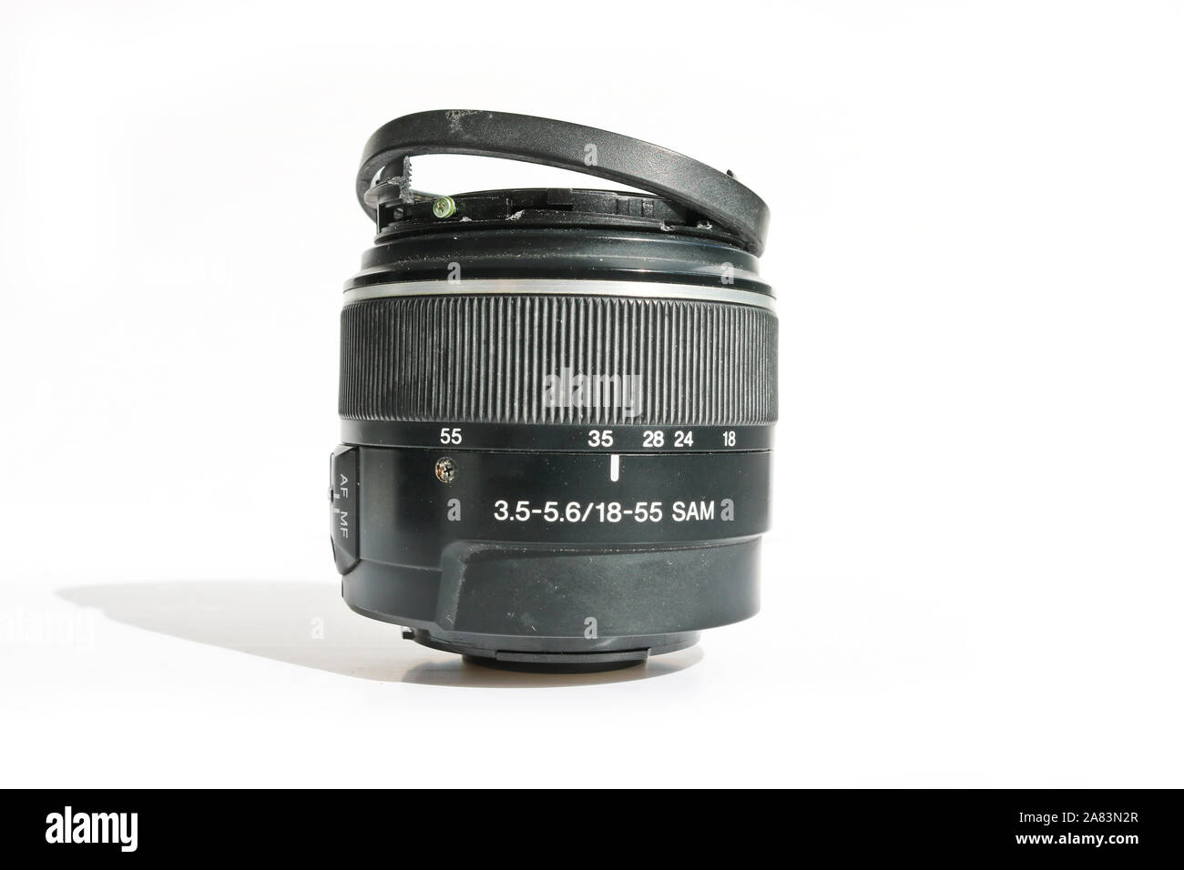 Broken SLR camera lens. Concept of careless attitude to photography. Stock Photo