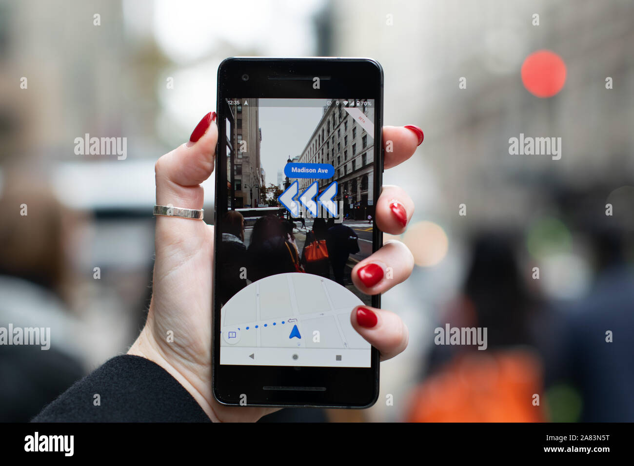 Newly released Google maps AR on Pixel 2 in directions mode displaying buildings and arrows in direction of travel towards Madison Avenue Stock Photo