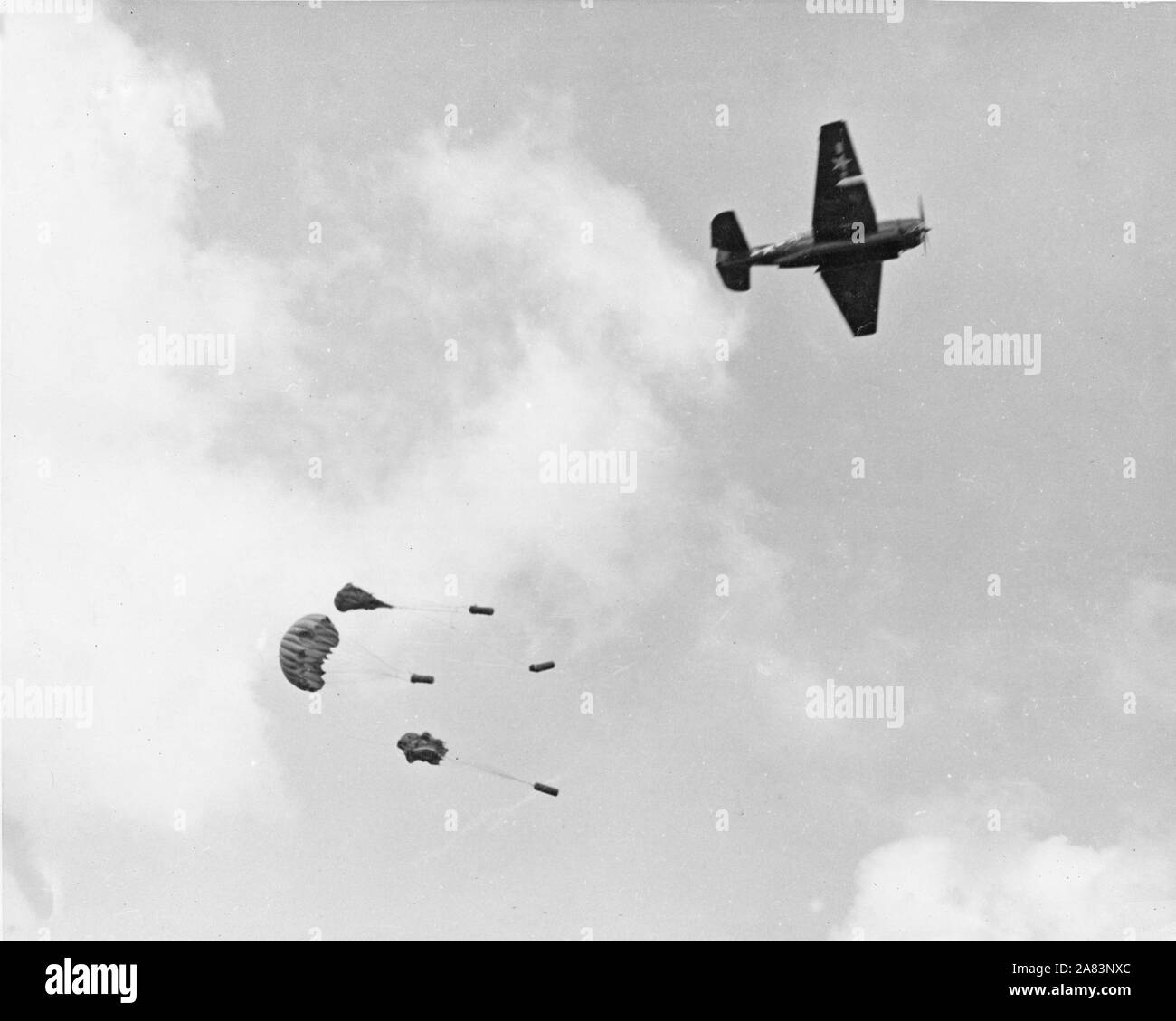 As troops attacked Shuri castle on Okinawa, parapacks dropped from a torpedo plane were one of the only ways to deliver food, supplies and ammo due to terenchal rains Stock Photo