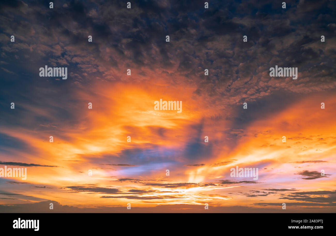 Beautiful sunset sky. Golden and orange sky and clouds with sunbeam ...