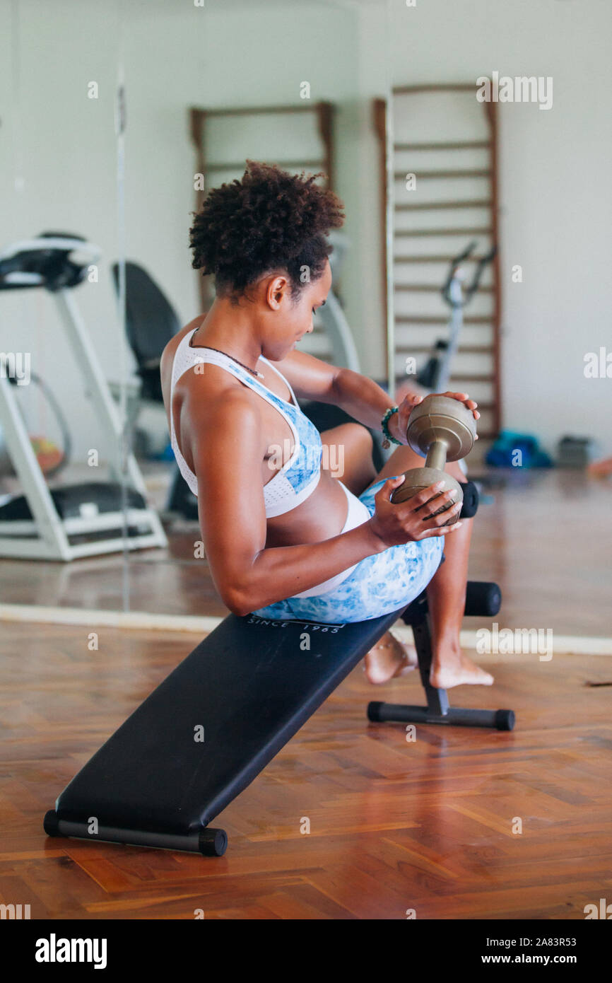 Young African American Woman Doing Abs Work Out At The Gym Bench
