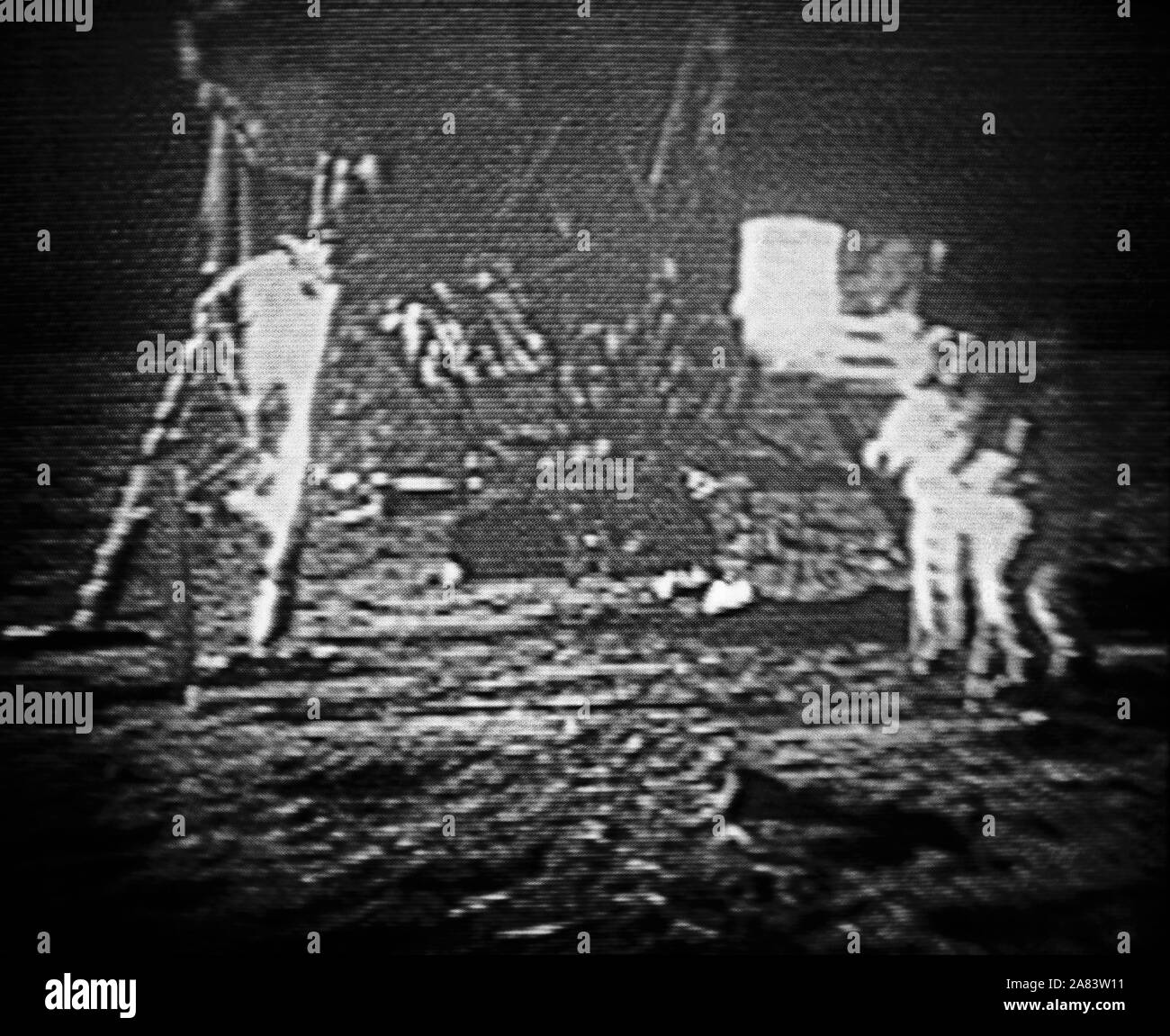 Neil A. Armstrong, commander; and Edwin E. Aldrin Jr., lunar module pilot, commemorate their historical landing and walk on the moon by planting the United States flag on the lunar surface camera Stock Photo