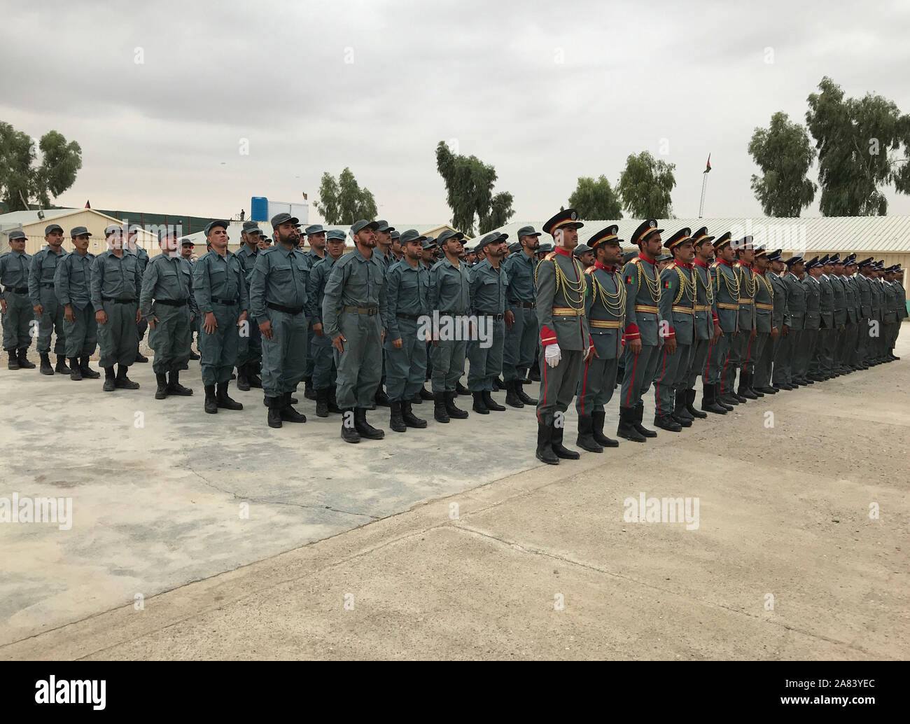 (191106) -- KANDAHAR, Nov. 6, 2019 (Xinhua) -- Afghan police officers take part in their graduation ceremony in Daman district of Kandahar province, Afghanistan, Nov. 5, 2019. A total of 246 police officers graduated from an Afghan National Police (ANP) training center in southern Kandahar province on Tuesday, local police said. (Photo by Arghand/Xinhua) Stock Photo