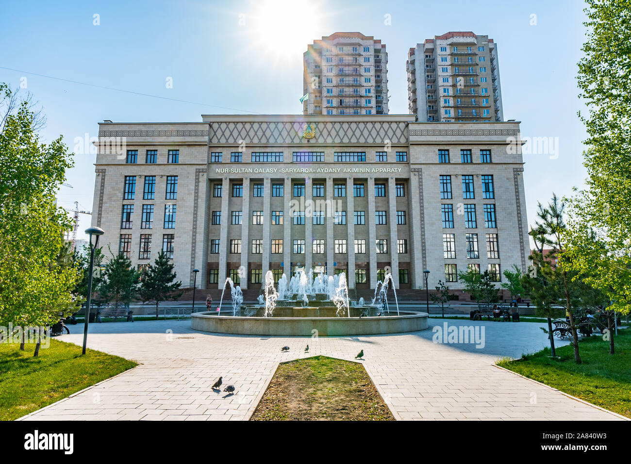 Nur-Sultan Astana Akimat of Saryarka Rayon Government Building with Picturesque Sun Rays on a Sunny Blue Sky Day Stock Photo