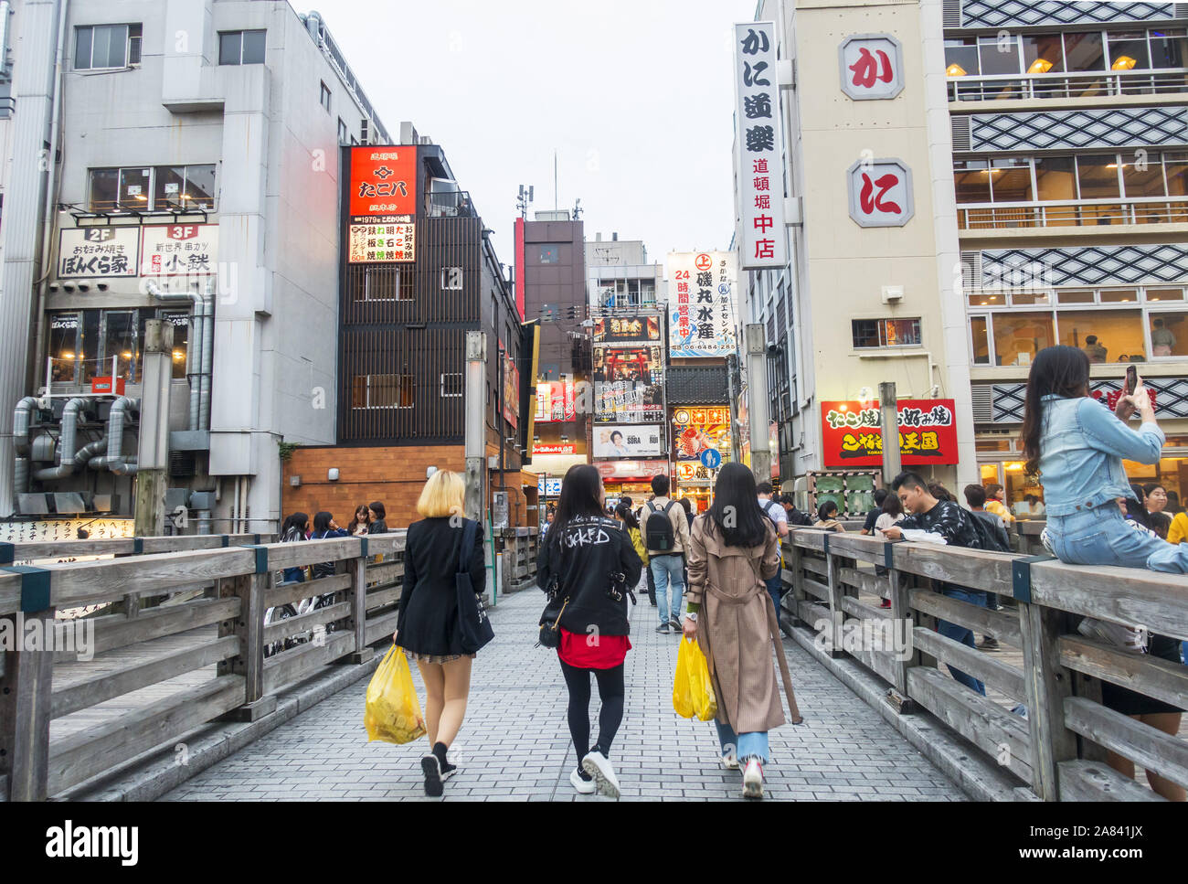 Osaka, Japan - November 3rd, 2019: Three fashionable girls walking in the popular area of Dotonbori. Stock Photo