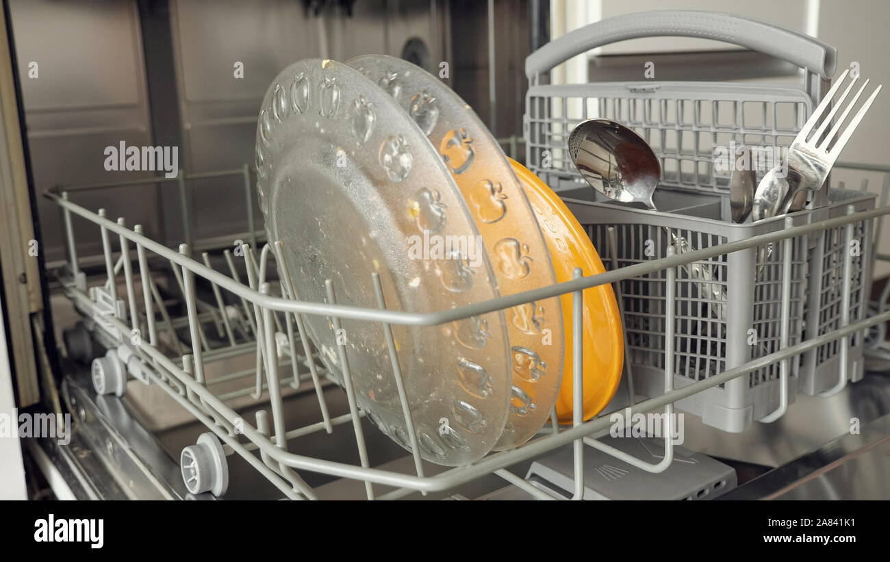 a dirty plates and cutlery in dishwasher in kitchenware Stock Photo Alamy