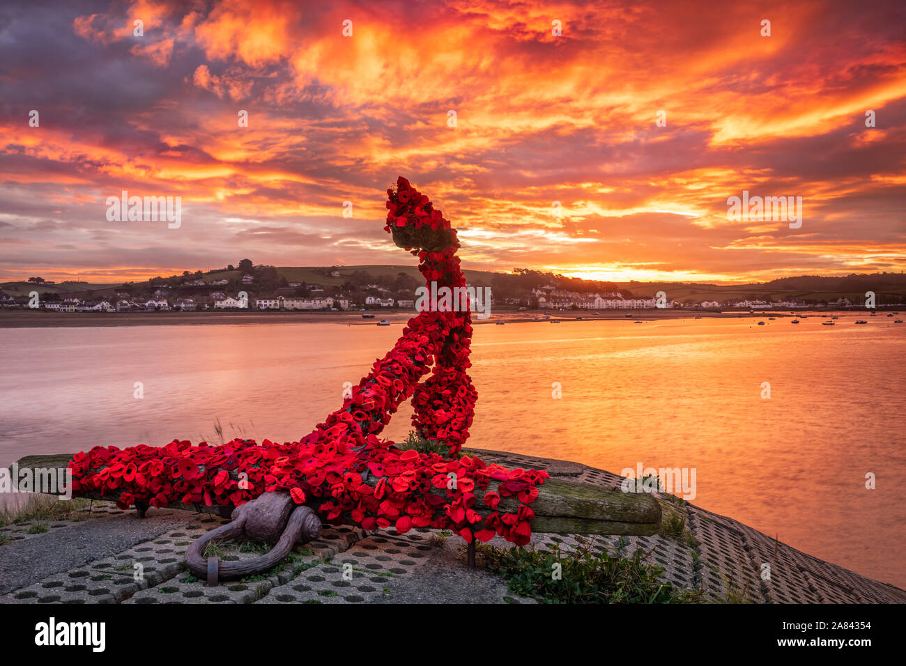 Appledore, North Devon, England. Wednesday 6th November 2019. UK Weather. After a cold night there was a  colourful sunrise over the River Torridge estuary at Appledore in North Devon. The landmark anchor at Appledore has been covered by the local community with knitted poppies in preparation for the forthcoming Remembrance Sunday. Terry Mathews/Alamy Live News. Stock Photo
