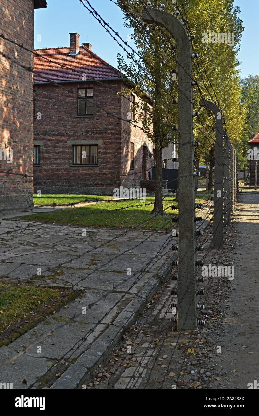 Buildings and barb wire fence in Auschwitz memorial museum Stock Photo