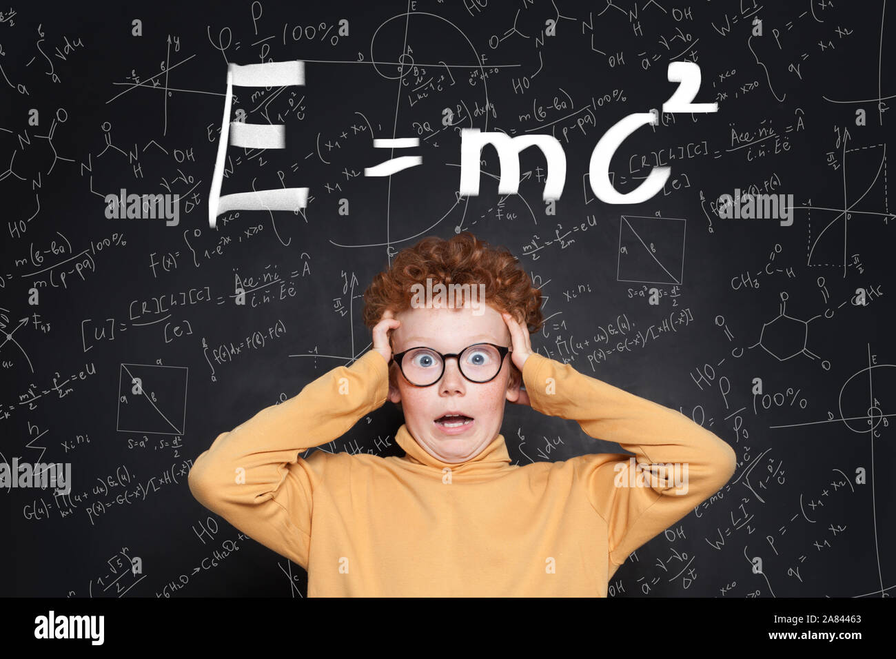 Shocked kid and science and maths formulas Stock Photo